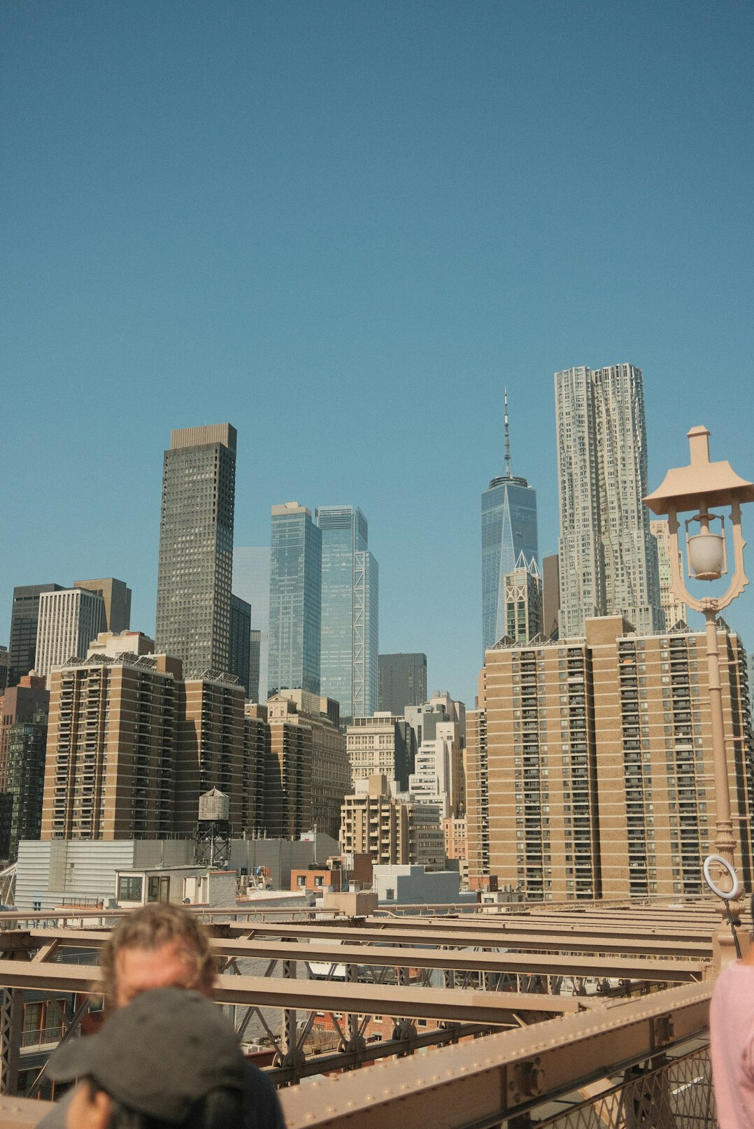 Wide view of a city skyline with pedestrians below