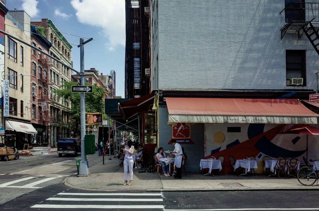 Street corner with colorful murals and passersby