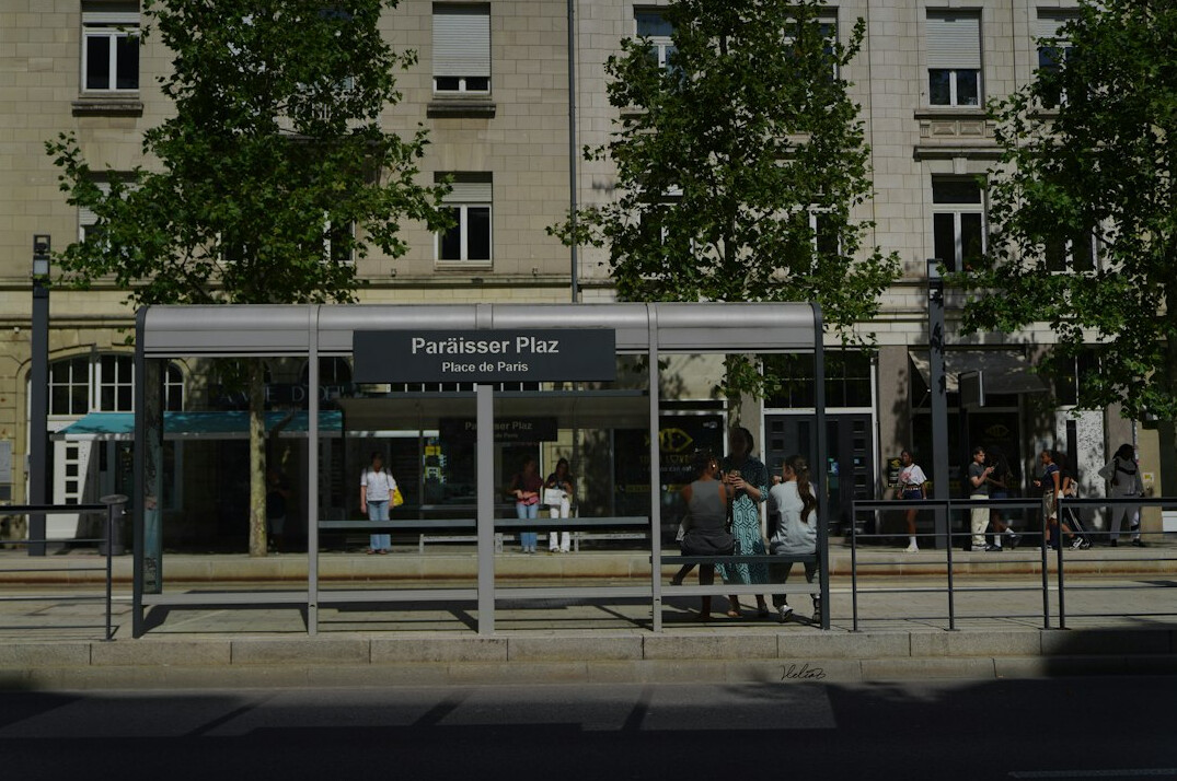 Commuters waiting at a city bus stop