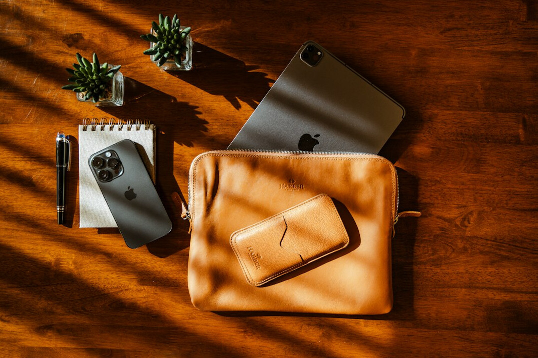 Camera and notebook on a wooden table